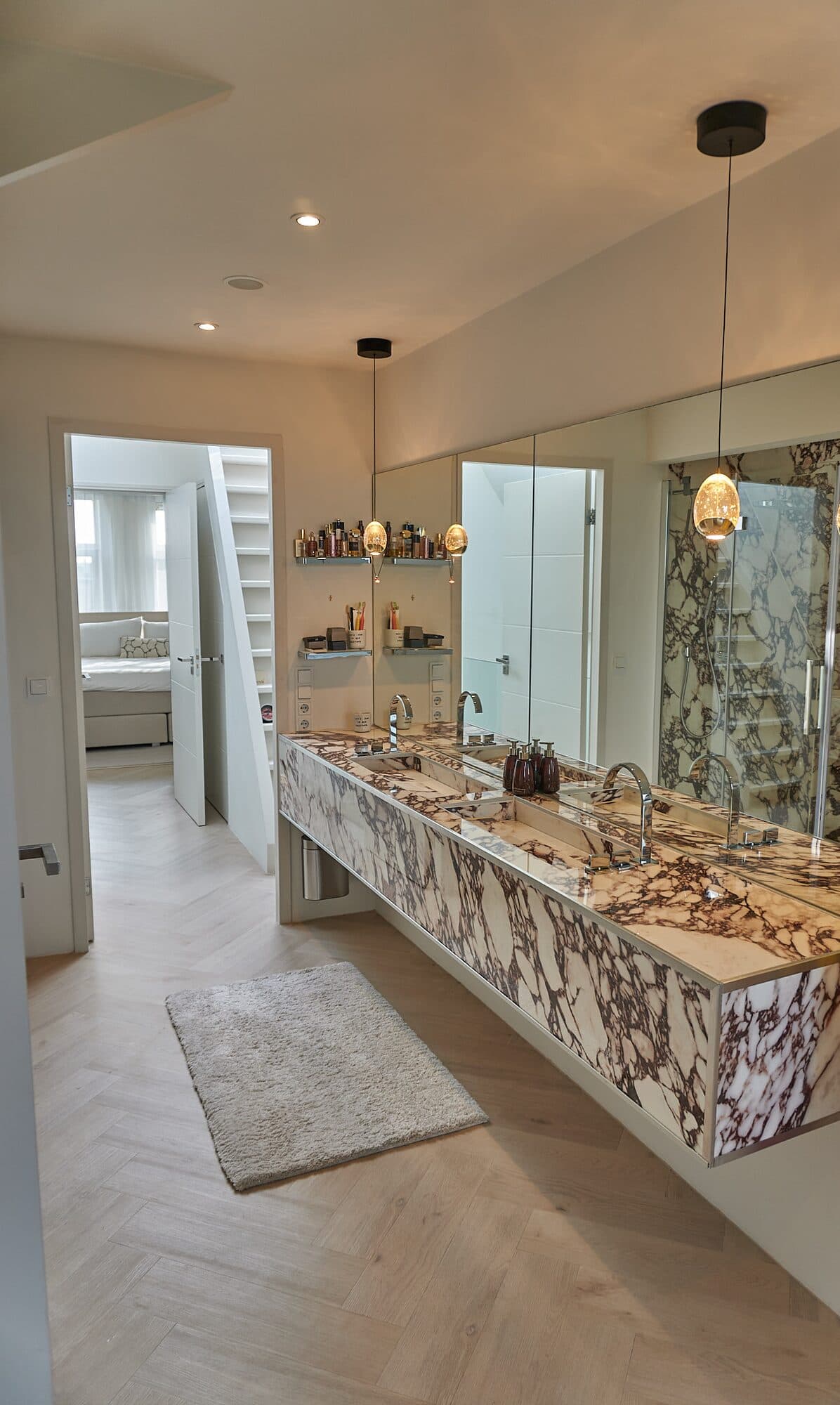 Calacatta Viola vanity, slabs book-matched across the front and set in a finished bathroom